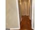 Hallway with hardwood floors and neutral paint, leading to several doorways at 503 Roy Huie Rd, Riverdale, GA 30274