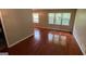 Bright living room featuring gleaming hardwood floors and multiple windows for ample natural light at 503 Roy Huie Rd, Riverdale, GA 30274