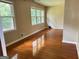 Spacious living room with hardwood flooring, neutral walls, and large windows offering natural light at 503 Roy Huie Rd, Riverdale, GA 30274