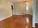 Inviting living room with hardwood floors, a decorative front door, and traditional lighting fixture at 503 Roy Huie Rd, Riverdale, GA 30274