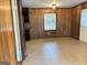 The living room features wood paneled walls, tile floors, and a unique glass block window at 503 Roy Huie Rd, Riverdale, GA 30274