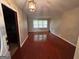 Bright living room with hardwood floors and abundant natural light from large windows at 503 Roy Huie Rd, Riverdale, GA 30274