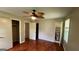 Large bedroom features hardwood flooring, ceiling fan, and access to a bathroom and closet at 503 Roy Huie Rd, Riverdale, GA 30274