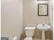 Powder room features neutral walls, pedestal sink, and a framed mirror at 1535 Lake Dow Rd, Mcdonough, GA 30252