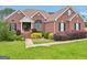 Inviting brick home featuring lush landscaping, green lawn, and classic architectural details at 1535 Lake Dow Rd, Mcdonough, GA 30252
