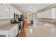Bright kitchen with white cabinets, stainless steel appliances, and hardwood floors at 1535 Lake Dow Rd, Mcdonough, GA 30252