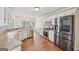 Bright kitchen featuring stainless steel appliances, white cabinets, and hardwood floors, offering modern elegance at 1535 Lake Dow Rd, Mcdonough, GA 30252