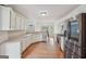 Spacious kitchen featuring stainless steel appliances, white cabinetry, and hardwood flooring at 1535 Lake Dow Rd, Mcdonough, GA 30252