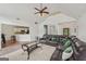 Spacious living room with leather sectional, ceiling fan, and open layout, perfect for entertaining at 1535 Lake Dow Rd, Mcdonough, GA 30252