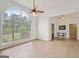 Bright living room featuring hardwood floors, a ceiling fan, and a large arched window that lets in natural light at 1535 Lake Dow Rd, Mcdonough, GA 30252