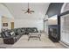 Bright living room with a comfortable leather sectional, modern ceiling fan, and cozy fireplace at 1535 Lake Dow Rd, Mcdonough, GA 30252