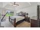 Comfortable main bedroom with a ceiling fan, an ornamental bed frame, and a sliding glass door to the outdoors at 1535 Lake Dow Rd, Mcdonough, GA 30252