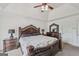 Comfortable main bedroom featuring an ornamental bed frame, a ceiling fan, and coordinating bedside furniture at 1535 Lake Dow Rd, Mcdonough, GA 30252