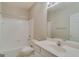 Bathroom featuring a white tiled shower, toilet, and vanity at 124 Camry Sw Ln, Grayson, GA 30017