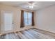 Bedroom showcasing wood-look floors, ceiling fan and a window with curtains and door to the outside at 124 Camry Sw Ln, Grayson, GA 30017