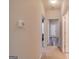 Inviting hallway featuring neutral walls and a view into a room with wood-look flooring at 124 Camry Sw Ln, Grayson, GA 30017