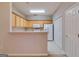 Functional kitchen with light wood cabinets, white appliances, and a breakfast bar at 124 Camry Sw Ln, Grayson, GA 30017