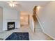 Spacious living area with a fireplace, adjacent dining room, and staircase access at 124 Camry Sw Ln, Grayson, GA 30017