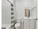 Bathroom featuring a shower-tub combination, toilet, and single sink vanity with tiled walls at 3525 Montebello Pkwy, Cumming, GA 30028