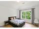 Bedroom with tray ceilings, hardwood floors, a modern bed and large window at 3525 Montebello Pkwy, Cumming, GA 30028
