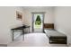 Well-lit bedroom with a bed, desk, and neutral tones with hardwood style flooring at 3525 Montebello Pkwy, Cumming, GA 30028