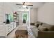 Cozy bonus room featuring a sofa, desk, TV, and ample natural light from the window at 3525 Montebello Pkwy, Cumming, GA 30028