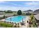 Large community pool with plenty of seating areas, umbrellas, and a tranquil lake view, perfect for relaxation at 3525 Montebello Pkwy, Cumming, GA 30028