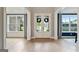 Bright foyer showcases a white double-door entry, complemented by hardwood floors and natural light from surrounding windows at 3525 Montebello Pkwy, Cumming, GA 30028