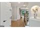 Hallway features hardwood floors, elegant staircase with wooden railings, and decorative arched niche for added character at 3525 Montebello Pkwy, Cumming, GA 30028
