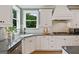 Bright kitchen with a stainless steel dishwasher, gas cooktop, and modern countertops at 3525 Montebello Pkwy, Cumming, GA 30028