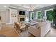 Spacious living room with a stone fireplace, built-in shelves, and comfortable seating at 3525 Montebello Pkwy, Cumming, GA 30028