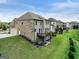 Back of the house with a wooden deck, a lush green lawn, and features a brick and grey siding exterior at 3525 Montebello Pkwy, Cumming, GA 30028