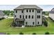 View of the rear of the house with a deck and a large backyard, featuring modern design and ample natural light at 3525 Montebello Pkwy, Cumming, GA 30028