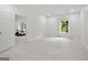 Bright and airy room with neutral walls, large window and doorway leading to an additional space at 3525 Montebello Pkwy, Cumming, GA 30028