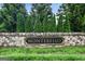Stone community sign surrounded by landscaping and a grass lawn at 3525 Montebello Pkwy, Cumming, GA 30028
