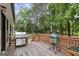 Spacious back deck with built-in grill, wooden railing, and green egg smoker for outdoor entertaining at 4733 Julian Way, Acworth, GA 30101