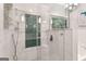 Contemporary bathroom showcasing a glass shower with mosaic tiling and a modern chandelier at 4733 Julian Way, Acworth, GA 30101