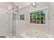 Bright bathroom with a soaking tub, a separate glass shower, and a garden window at 4733 Julian Way, Acworth, GA 30101