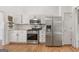 Well-lit kitchen features stainless steel appliances, white cabinetry, and tile backsplash at 4733 Julian Way, Acworth, GA 30101
