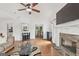 Open living room with hardwood floors and fireplace, adjoins dining area at 4733 Julian Way, Acworth, GA 30101
