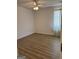 A bright bedroom with ceiling fan, window, and modern flooring at 135 Courtyard Ln, Fayetteville, GA 30215