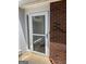Front door of home featuring a white-trimmed glass storm door and brick facade at 135 Courtyard Ln, Fayetteville, GA 30215