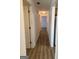 A hallway featuring modern floors and multiple doorways at 135 Courtyard Ln, Fayetteville, GA 30215
