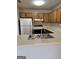 Kitchen with wood cabinets, a white refrigerator, and laminate countertops at 135 Courtyard Ln, Fayetteville, GA 30215