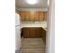 A kitchen featuring wood cabinets, appliances, and modern flooring at 135 Courtyard Ln, Fayetteville, GA 30215
