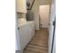 Laundry room with white washer, dryer, and storage space at 135 Courtyard Ln, Fayetteville, GA 30215
