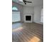 Open living room with fireplace, vaulted ceilings, large window, and wood-look flooring at 135 Courtyard Ln, Fayetteville, GA 30215