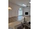 View from the kitchen looking into the living room, featuring a brick fireplace at 135 Courtyard Ln, Fayetteville, GA 30215