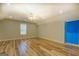 Bright bedroom with hardwood floors, neutral walls, a large window, and a ceiling fan at 2436 Green Hollow Ct, Conyers, GA 30012