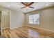 Spacious bedroom featuring hardwood floors, a ceiling fan, large window and walk in closet at 2436 Green Hollow Ct, Conyers, GA 30012